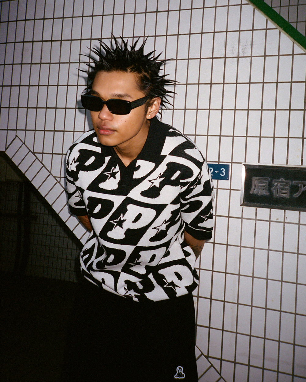 Pawa Speed Sports P Check Knit Polo in black and white, worn at Harajuku station, Tokyo, Season 5 lookbook