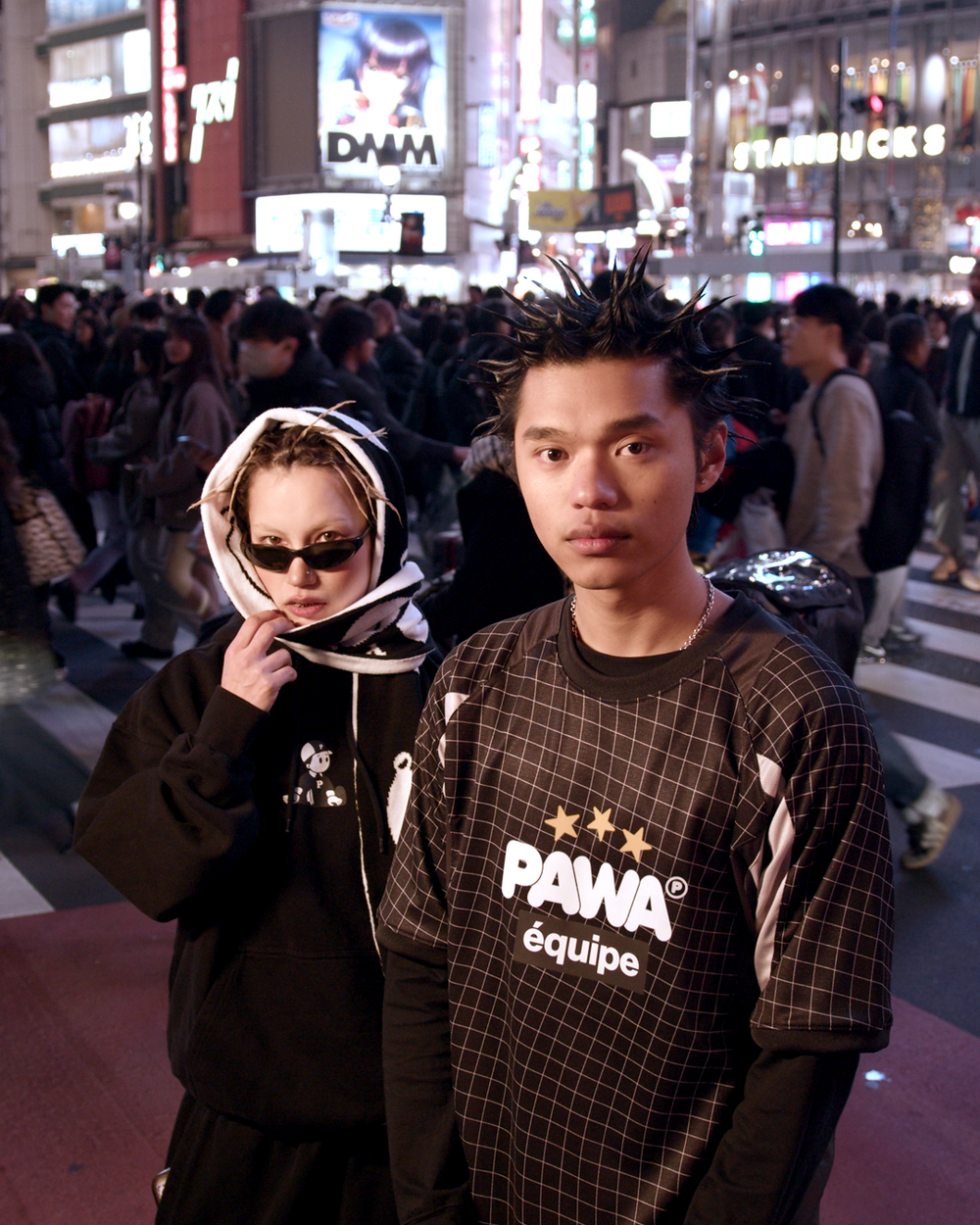 Pawa Speed Sports Equipe Football Shirt in black and white and Boy Hoodie in black, worn at Shibuya crossing Tokyo at night, Season 5 lookbook
